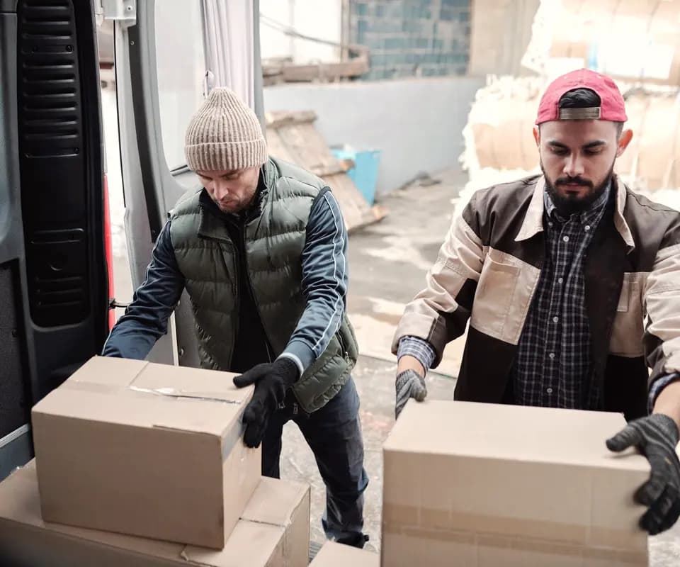 Warehouse staff loading packed boxes for shipping